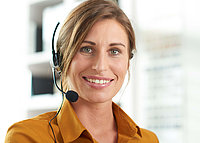 Responsible action is the basis of our business. A nice ladies smiling into the camera with a headset on her ear.