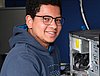 A young man repairing a computer