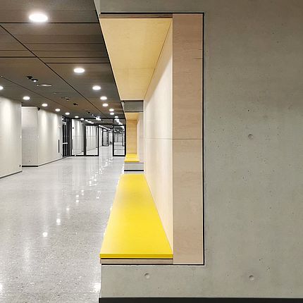 Willy-Brandt-Schule Köln Hallway Seating One can sea a hallway with a bench integrated into a wall