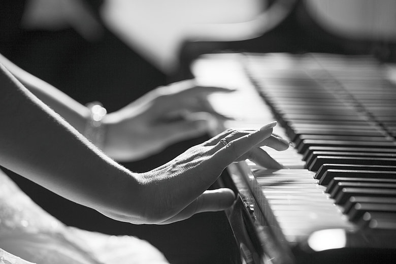 Pianoman A black and white picture of a lady, of whom only her hands can be seen, on a piano.