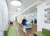 Hospital corridor with nurses' station in a modern, white design