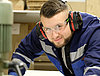 A man in protective gear operating heavy machinery