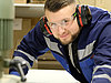 A man in protective gear operating heavy machinery