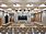 The photo shows the great hall of the new town hall. It features a big screen, light materials and some wooden elements.