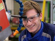 Representative image Wood Processing A young man in protective gear operating a machine processing wood