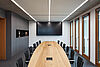 The picture shows a modern conference room.