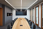 The picture shows a modern conference room.