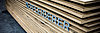 The picture shows a close-up of a stack of Pfleiderer raw particleboards with the logo in the entrance area of the Wroclaw site.