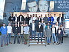 Man sieht ein Gruppenfoto der Teilnehmer der Nacht am Westring, welche vor und in einem Ausstellungsfahrzeug posieren