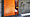 Orange-coloured door next to a walk-in shower
