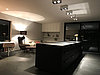 The kitchen block in matt black is an eye-catcher in the dining area.