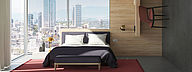 De foto toont een hotelkamer met een bed voor grote hoekramen. Voor de muren en het meubilair zijn verschillende materialen van hoge kwaliteit gebruikt.