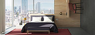 L'image montre une chambre d'hôtel avec un lit devant de grandes fenêtres d'angle. Plusieurs matériaux de haute qualité sont utilisés pour les murs et les meubles.