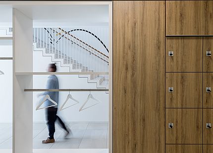Coatroom, lockers, and wood-effect wall cladding at the Erika Fuchs House Museum