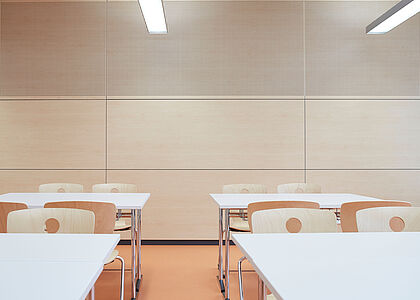 Wall panelling in a classroom with a light wood finish Wall panelling in a classroom with a light wood finish