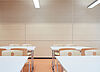 Wall panelling in a classroom with a light wood finish